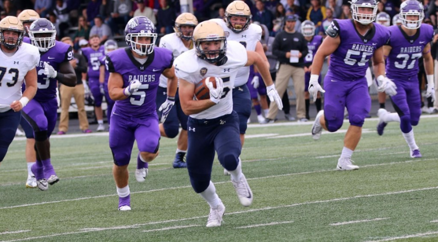 
Sophomore running back Mike Canganelli rushes past the Mount Union defense on Sept. 23.