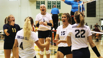 The Blue Streaks women’s volleyball team celebrates after a 3–0 victory over Allegheny College.