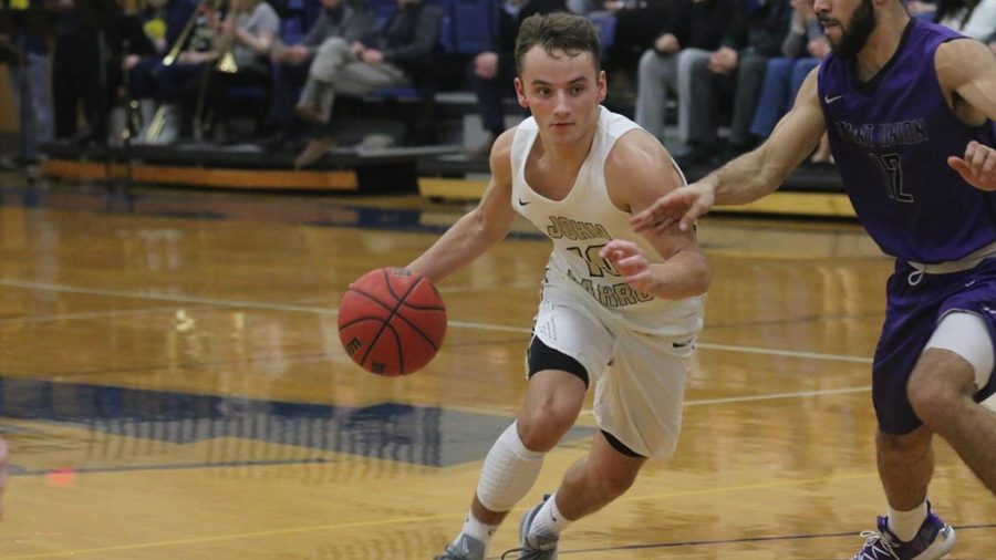 Junior Sean Flannery drives to the hoop against a Mount Union defender at the DeCarlo Varsity Center. (JCU Sports Information)