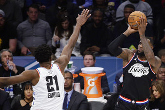 CORRECTS TO THE LAKERS, NOT THE CAVALIERS - Team LeBron's LeBron James, of the Los Angeles Lakers, shoots over Team Giannis' Joel Embiid, of the Philadelphia 76ers, during the second half of an NBA All-Star basketball game, Sunday, Feb. 17, 2019, in Charlotte, N.C. (AP Photo/Gerry Broome)