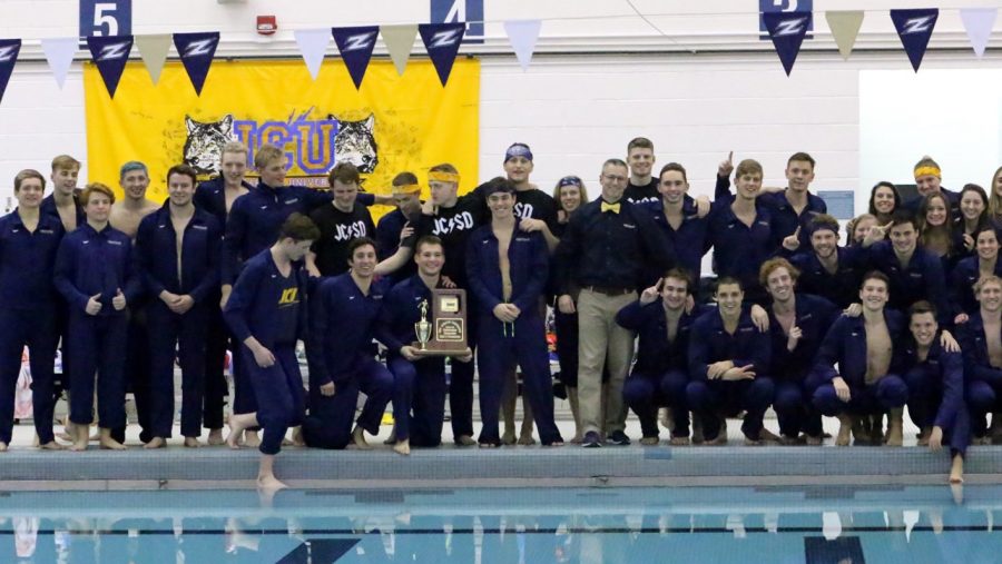 The JCU men's swimming and diving team celebrates after winning the OAC Championship.