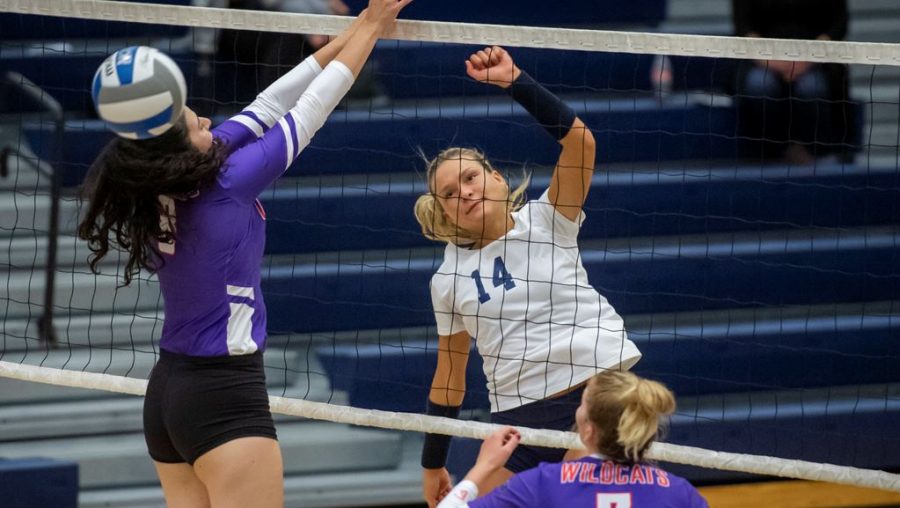 Sophomore Cassi Calamuncui (14) leaps in front of the net in a game in a game on Friday, Sept. 6, 2019.