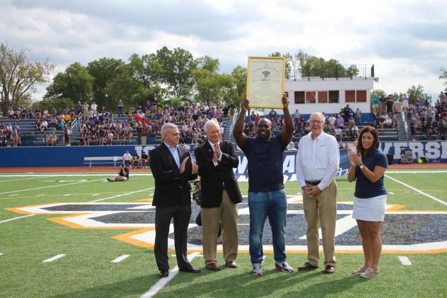 Pictured above is London Fletcher, showing his NFL Hall of Fame Plaque
to the JCU crowd at halftime of the football game against Mount Union.(Photo by JCU Sports Information). 