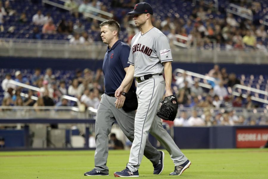 In this May 1, 2019, file photo, Cleveland Indians starting pitcher Corey Kluber, right, leaves during the fifth inning of the team's baseball game against the Miami Marlins, in Miami. For the first time since 2015, baseball’s postseason will go on without the Indians. (AP Photo/Lynne Sladky, File)