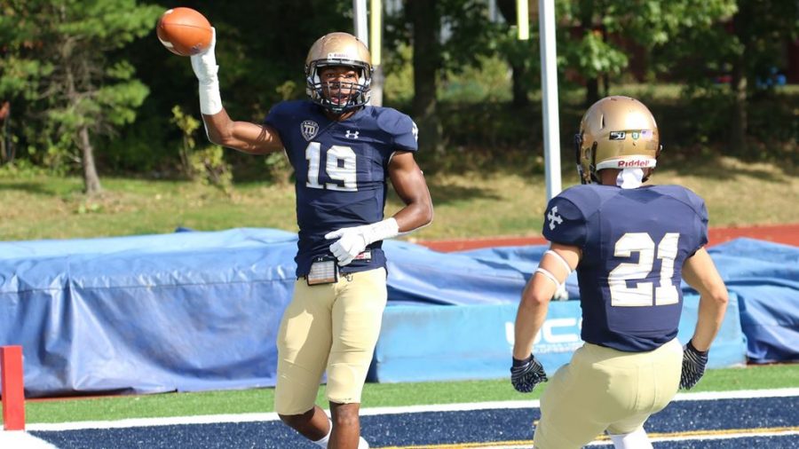 Sophomore Keyshawn Colmon (left, 19) and senior Kody Kidd (right, 21) celebrate after a touchdown at Don Shula Stadium on Oct. 5.