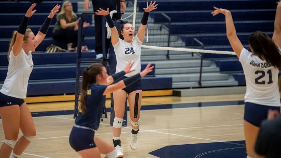 The+JCU+women%E2%80%99s+volleyball+team+celebrates+after+scoring+a+point+in+a+game+on+the+road+during+the+2019+season.