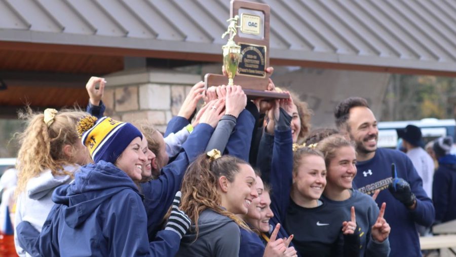 The womens cross country team celebrates the OAC Championship