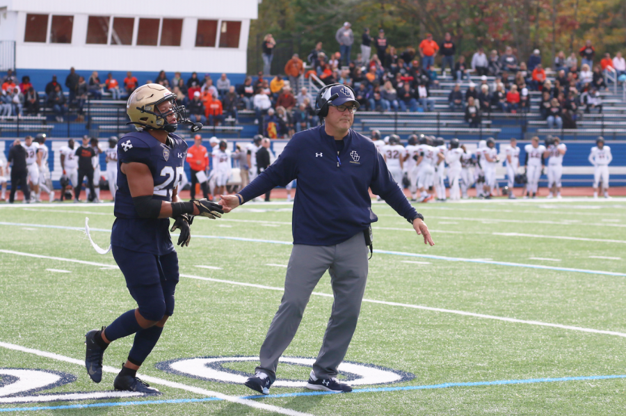 Senior defensive back Cole Griffin [right] and head coach Rick Finotti [left] high-five in a game against Ohio Northen. 