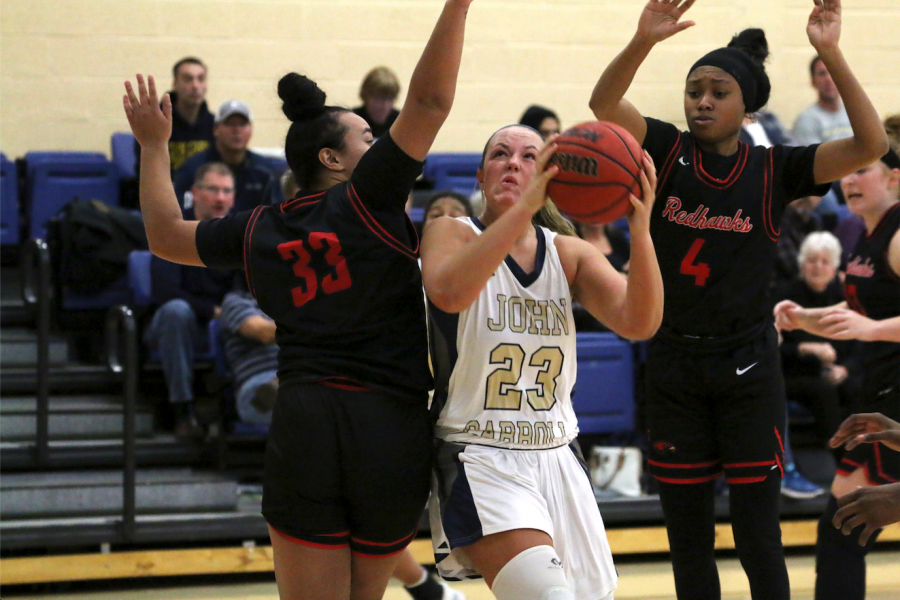 Junior Nicole Heffington [ball in hand] drives through the lane at the Tony DeCarlo Varsity Center during the JCU tip-off tournament. 
