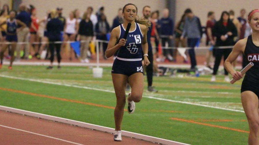 Junior Courtney Phoennik holds the baton and races at the Midwest Open at Spire Institute  