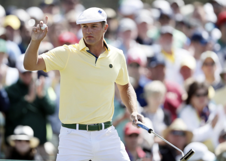 mateur Bryson DeChambeau holds up his ball after a birdie putt on the ninth hole during the second round of the Masters golf tournament Friday, April 8, 2016, in Augusta, Ga.