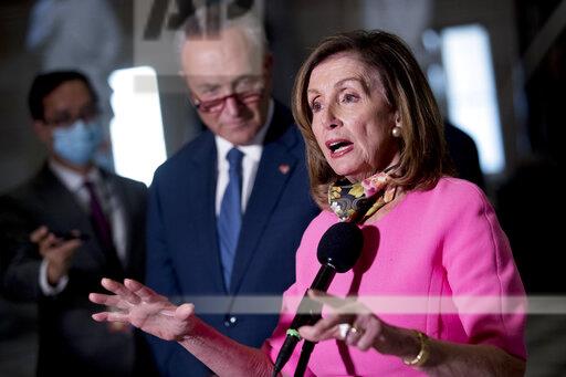 House Speaker Nancy Pelosi of Calif., center, accompanied by Senate Minority Leader Sen. Chuck Schumer of N.Y., left, speak to reporters following a meeting with Treasury Secretary Steven Mnuchin and White House Chief of Staff Mark Meadows as they continue to negotiate a coronavirus relief package on Capitol Hill in Washington, Friday, Aug. 7, 2020. (AP Photo/Andrew Harnik)