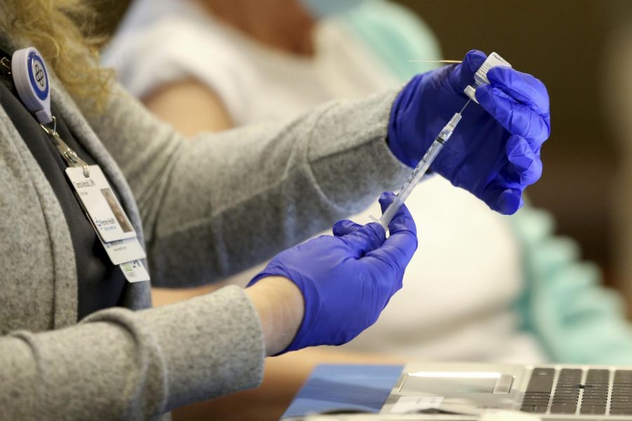 A nurse prepares to administer a COVID-19 vaccine at Atrium Medical Center in Middletown, Ohio (Kareem Elgazzar/The Cincinnati Enquirer via AP)