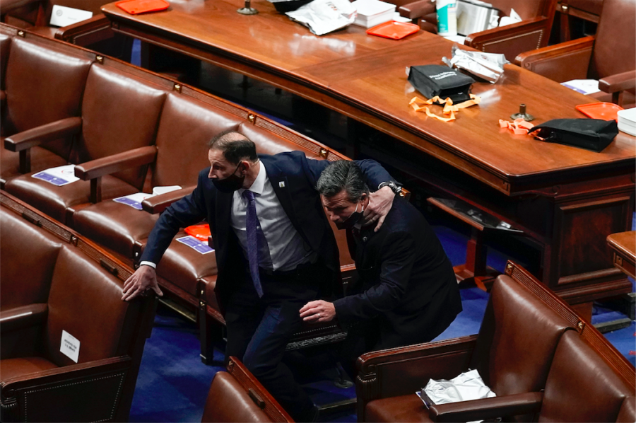 Lawmakers evacuate the floor as protesters try to break into the House Chamber at the U.S. Capitol on Wednesday, Jan. 6, 2021, in Washington. 