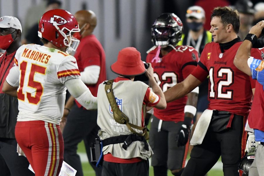 In this Nov. 29, 2020, file photo, Tampa Bay Buccaneers quarterback Tom Brady (12) congratulates Kansas City Chiefs quarterback Patrick Mahomes (15) after their NFL football game in Tampa, Fla. The Super Bowl matchup features the most accomplished quarterback ever to play the game who is still thriving at age 43 in Brady against the young gun who is rewriting record books at age 25. (AP Photo/Jason Behnken, File)