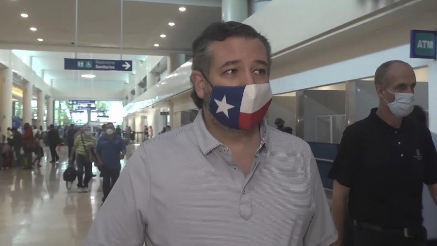 In this image from video, Sen. Ted Cruz, R-Texas, walks to check in for his flight back to the U.S., at Cancun International Airport in Cancun, Mexico, Thursday, Feb. 18, 2021. (AP Photo/Dan Christian Rojas)