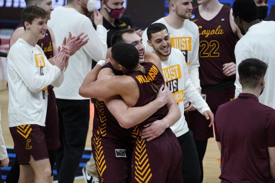 Loyola Chicago center Cameron Krutwig (25) and Loyola Chicago guard Lucas Williamson (1) celebrate after beating Illinois 71-58 after a mens college basketball game in the second round of the NCAA tournament at Bankers Life Fieldhouse in Indianapolis, Sunday, March 21, 2021. (AP Photo/Paul Sancya)