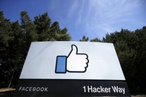 In this April 14, 2020, file photo, the thumbs up Like logo is shown on a sign at Facebook headquarters in Menlo Park, Calif. 