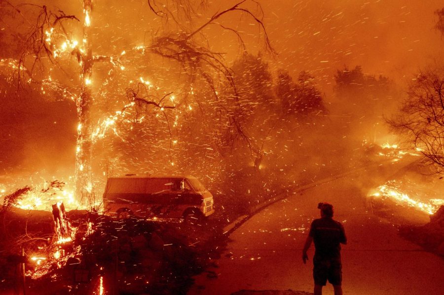 Bruce McDougal watches flames consume his property on Dec. 3, 2020 as the Bond Fire burns through the Silverado community in Orange County, Calif.