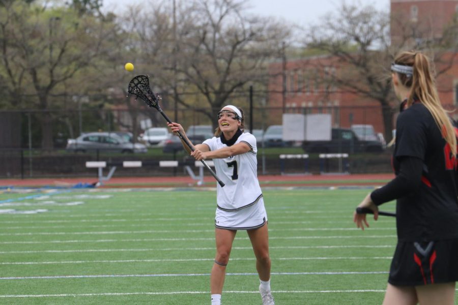 Senior Colleen Grombala sends over a pass to a teammate against Muskingum at Don Shula Stadium on April 24, 2021.