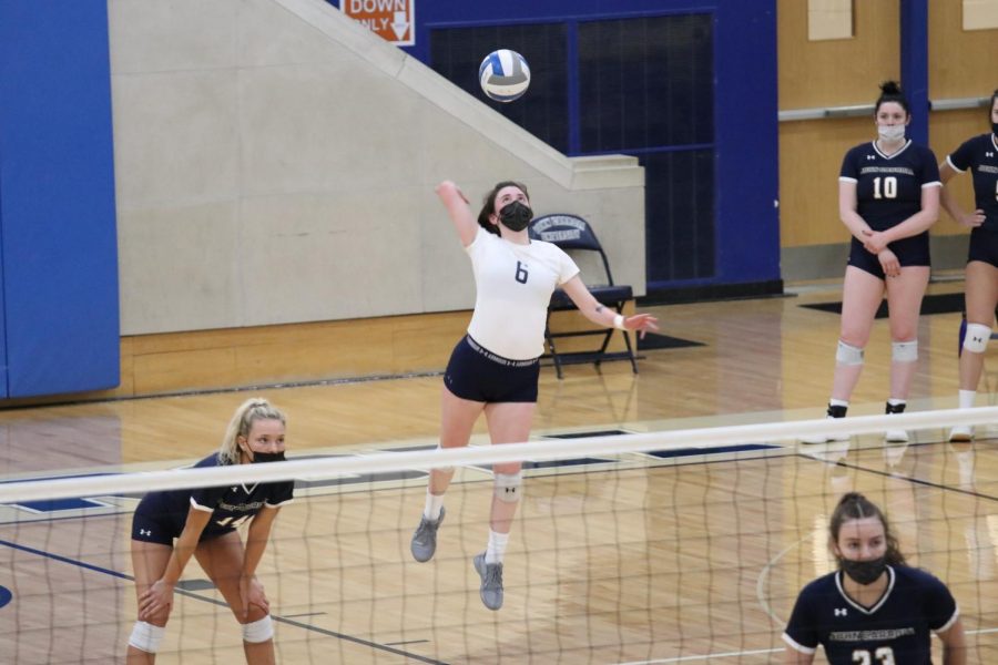 Anna Coughlin serving in a 2021 volleyball match. Coughlin was named to the All-Tournament team over the weekend. 