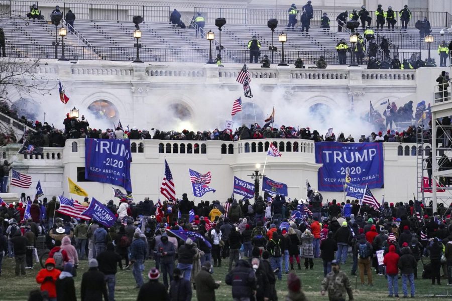 In this Jan. 6, 2021 file photo, violent protesters, loyal to President Donald Trump, storm the Capitol in Washington. A House committee tasked with investigating the Jan. 6 Capitol insurrection is moving swiftly to hold at least one of Donald Trump’s allies, former White House aide Steve Bannon, in contempt. That's happening as the former president is pushing back on the probe in a new lawsuit.