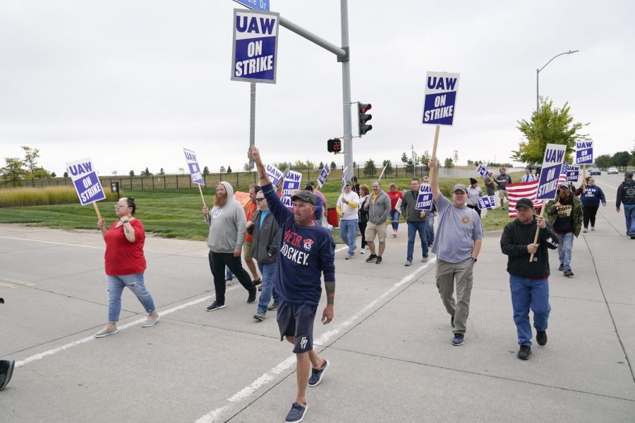 Members of the United Auto Workers strike outside of a John Deere plant, Wednesday, Oct. 20, 2021, in Ankeny, Iowa. About 10,000 UAW workers have gone on strike against John Deere since last Thursday at plants in Iowa, Illinois and Kansas.