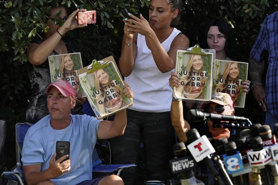 In this Wednesday, Oct. 20, 2021, file photo, Supporters of Gabby Petito hold up photos of Gabby after a news conference Wednesday, Oct. 20, 2021, in North Port, Fla. The FBI on Thursday, Oct. 21, 2021 identified human remains found in a Florida nature preserve as those of Brian Laundrie, a person of interest in the death of girlfriend Gabby Petito while the couple was on a cross-country road trip.