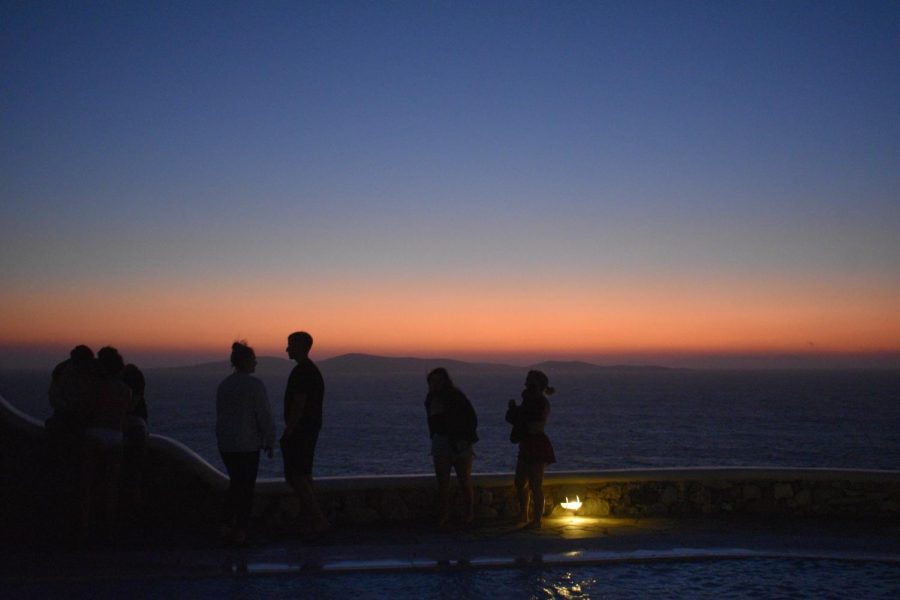 A sunset silhouetted by friends in Mykonos, Greece.