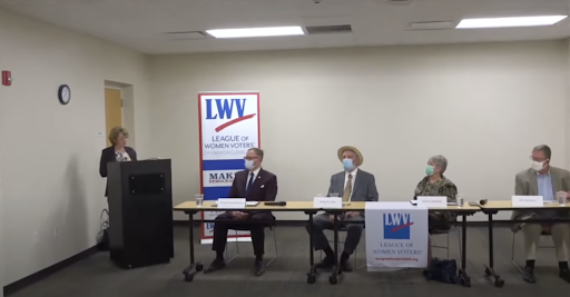 Deanna Fisher introduces the candidates. From left to right, Michael Dylan Brennan, Phil Atkins, Barbara Blankfeld, and Ken Simmons. 