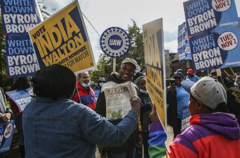 This Saturday, Oct. 23, 2021, file photo, shows supporters of Buffalo Mayor Byron Brown and mayoral candidate India Walton in an exchange near a polling center in Buffalo, N.Y.
