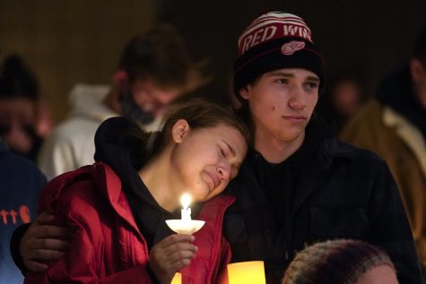 People attending a vigil embrace at LakePoint Community Church in Oxford, Mich., Tuesday, Nov. 30, 2021. Authorities say a 15-year-old sophomore opened fire at Oxford High School, killing several students and wounding multiple other people, including a teacher.