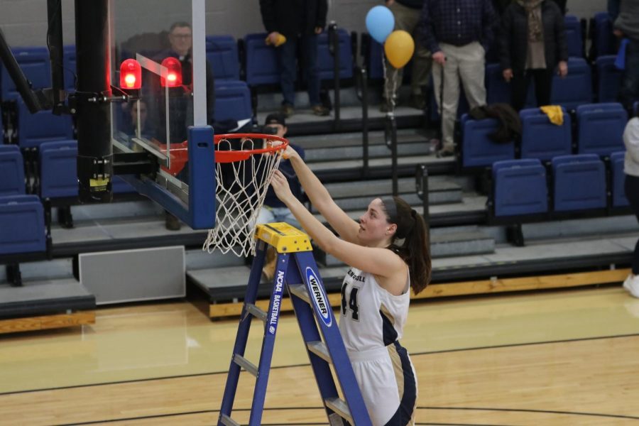 Senior Olivia Nagy cutting down the net after John Carrolls victory against Wilmington College. 