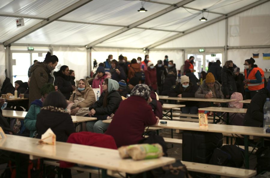 Refugees from the Ukraine wait in a tent for further transport after they arrived at the main train station in Berlin, Germany, Wednesday, March 16, 2022.
