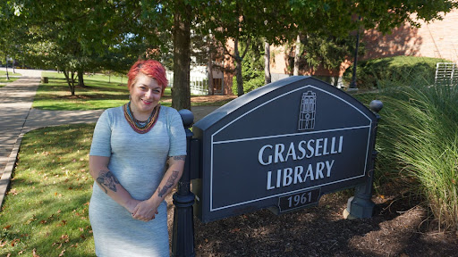 Wainwright poses outside of the library on a beautiful spring day.