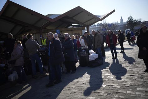People wait in a line to board a train leaving for Lviv in Ukraine at the train station in Przemysl, Poland, Monday, March 14, 2022. While tens of thousands of people have fled Ukraine every day since Russias invasion, a small but growing number are heading in the other direction. At first they were foreign volunteers, Ukrainian expatriate men heading to fight and people delivering aid. But increasingly, women are also heading back.