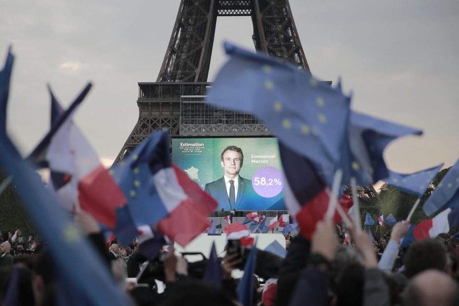 Supporters of French President Emmanuel Macron celebrate reports of his victory Sunday, April 24, 2022 in Paris.