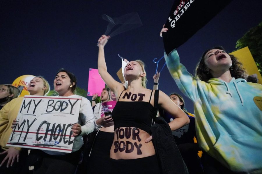 A crowd of people gather outside the Supreme Court, early Tuesday, May 3, 2022 in Washington.