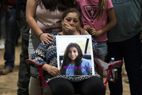 Esmeralda Bravo, 63, sheds tears while holding a photo of her granddaughter, Nevaeh, one of the Robb Elementary School shooting victims, during a prayer vigil in Uvalde, Texas, Wednesday, May 25, 2022.