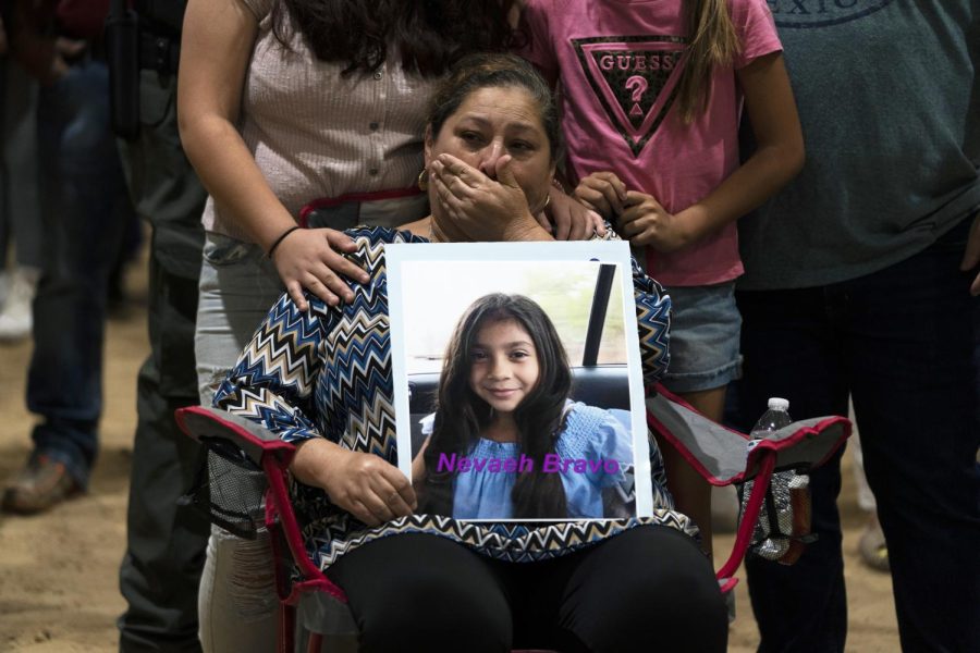 Esmeralda Bravo, 63, sheds tears while holding a photo of her granddaughter, Nevaeh, one of the Robb Elementary School shooting victims, during a prayer vigil in Uvalde, Texas, Wednesday, May 25, 2022.