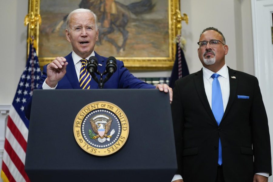 President+Joe+Biden+speaks+about+student+loan+debt+forgiveness+in+the+Roosevelt+Room+of+the+White+House%2C+Wednesday%2C+Aug.+24%2C+2022%2C+in+Washington.+Education+Secretary+Miguel+Cardona+listens+at+right.