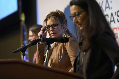 Republican Sarah Palin (center) and Democrat Mary Peltola (right) participate in a debate for Alaskas open US House seat.