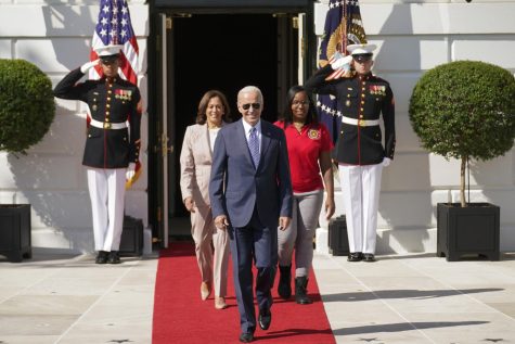 President Joe Biden arrives with Vice President Kamala Harris and Lovette Jacobs, a fifth-year IBEW Local 103 electrical apprentice in Boston, during a ceremony about the Inflation Reduction Act of 2022, on the South Lawn of the White House in Washington, Tuesday, Sept. 13, 2022.