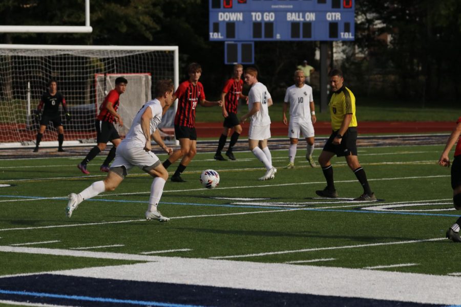 Junior Patrick Koenig working to cross the ball to his teammates waiting in by the goal in the game vs. CMU.