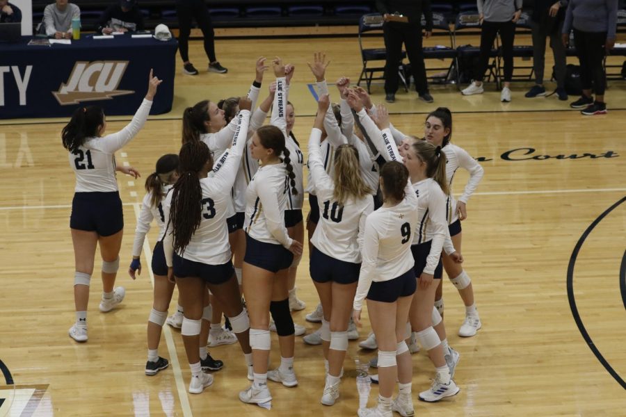 The JCU Volleyball team brings it in following one of their wins this season. 