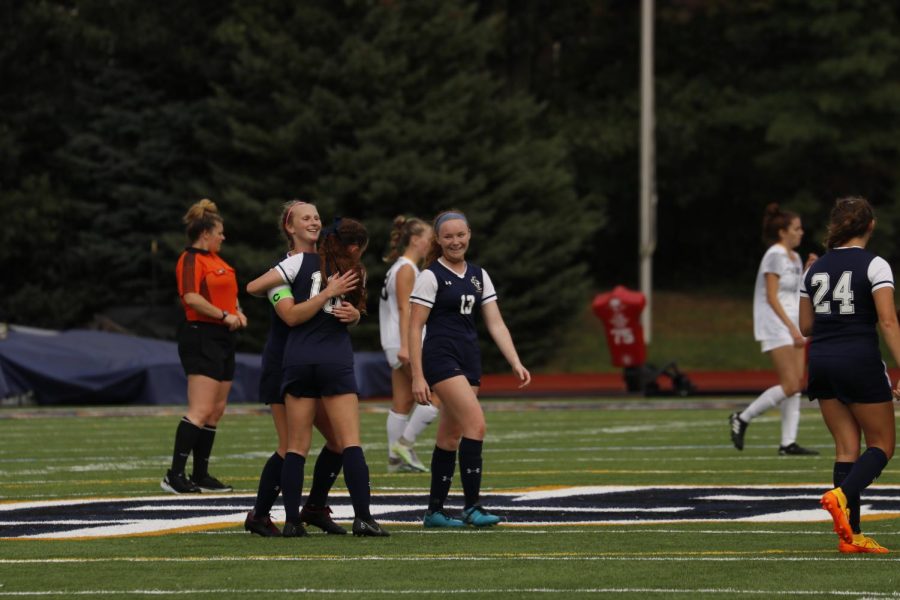 The JCU Womens Soccer team celebrates after winning their game on Sunday. 