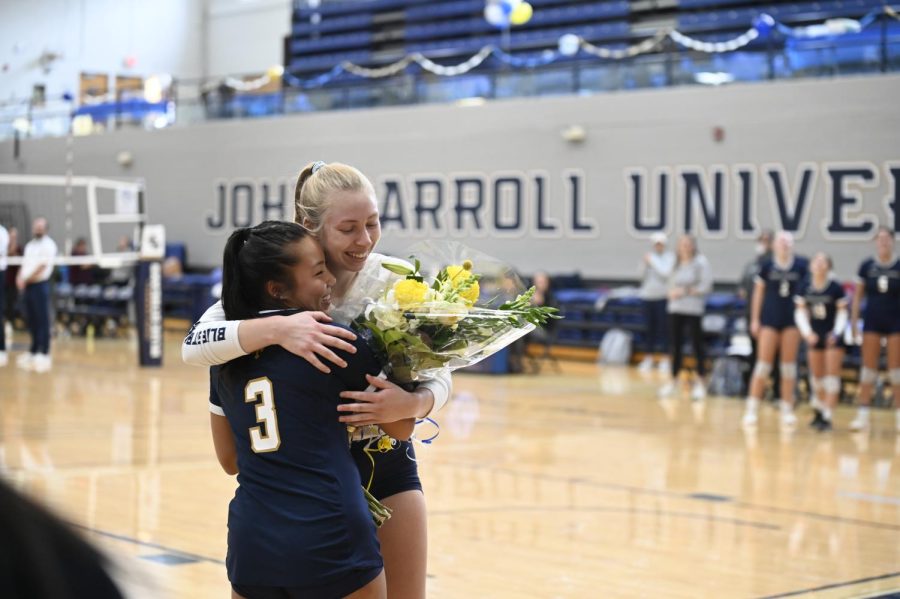Cindy Woo and Lexi MacDonald embrace on the Senior Day game on Saturday.