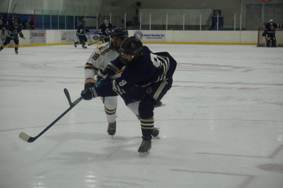 Payton Fogarty gets a shot around Toledo defender during a game this season.