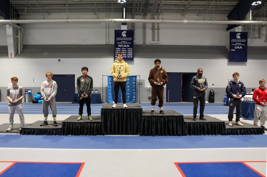 Andrew Perelka stands a top the podium as he is crowned the victor of the 133 lbs. weight class and surpassed the most career wins in JCU wrestling history.