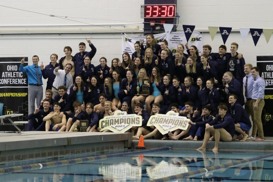 Both teams pose for their photo with the OAC Champion sign this year in Akron.